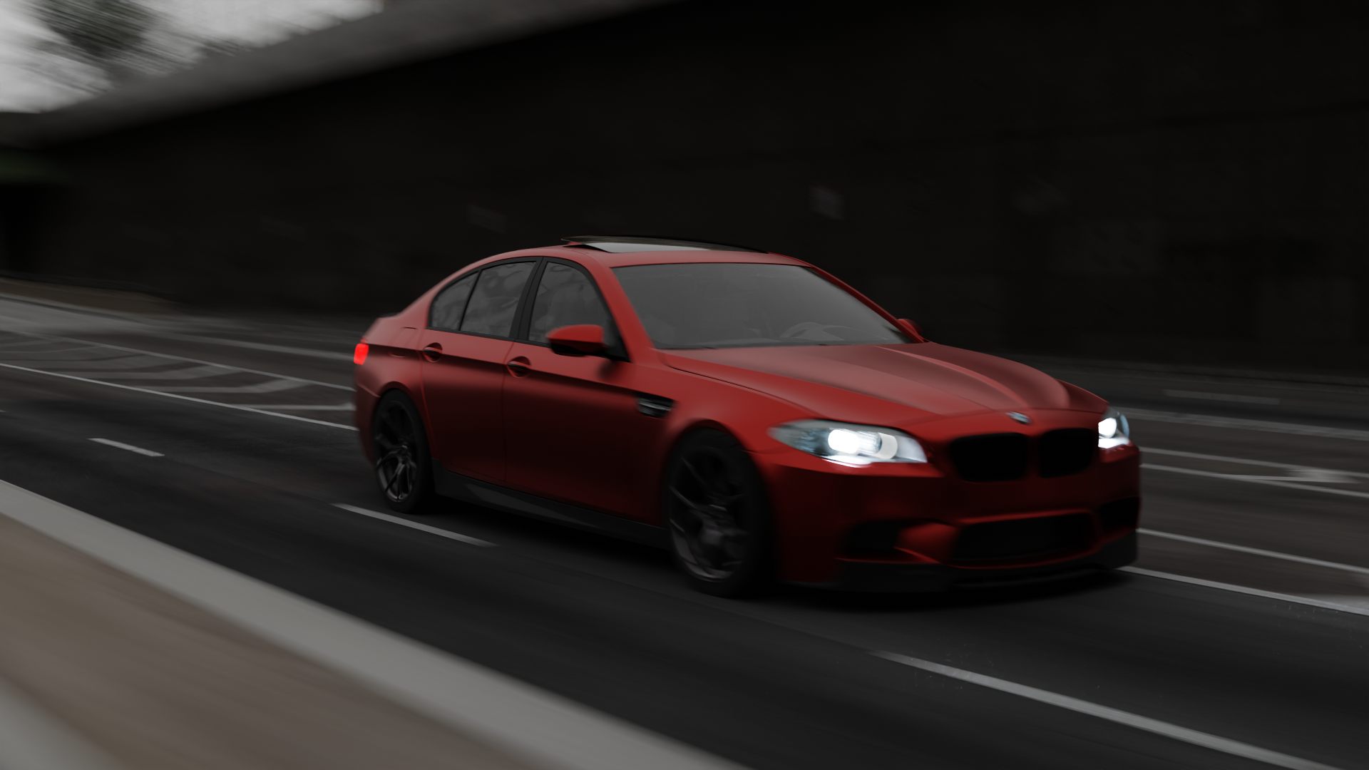 A matte red sports sedan speeding through a dark tunnel with motion blur